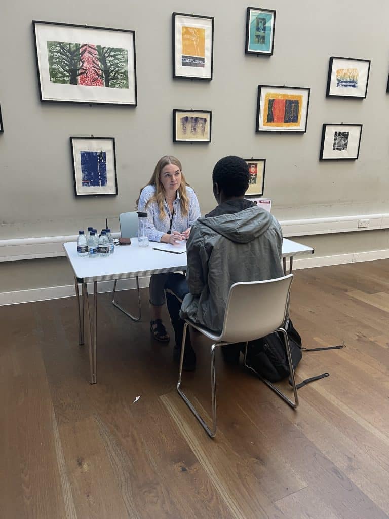 two people meeting in an art gallery