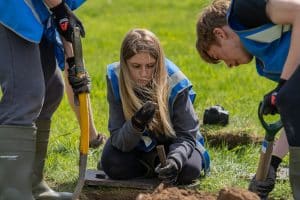 Young adults excavating some ground